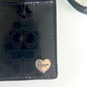Coach black patent leather lanyard.